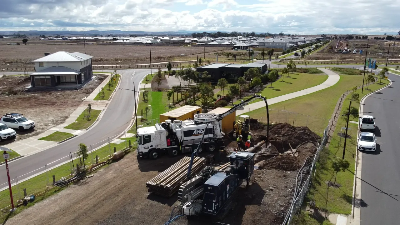 An AHD truck sitting on a worksite surrounded by workers